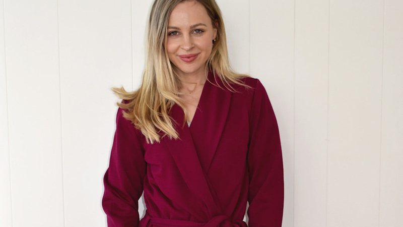 A woman wearing a magenta merino ponte dressing gown